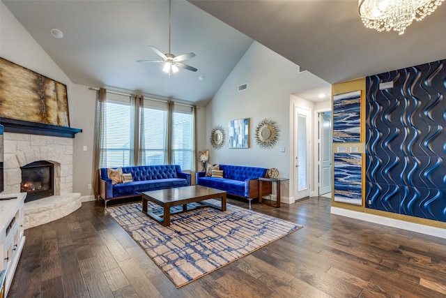 living area featuring visible vents, ceiling fan with notable chandelier, a fireplace, and wood finished floors