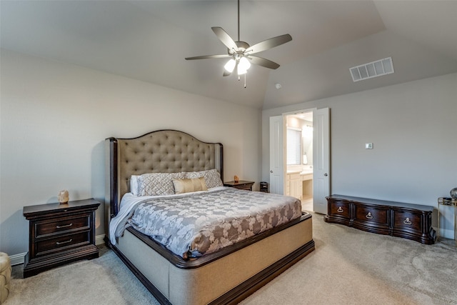 bedroom with ensuite bath, vaulted ceiling, visible vents, and light carpet