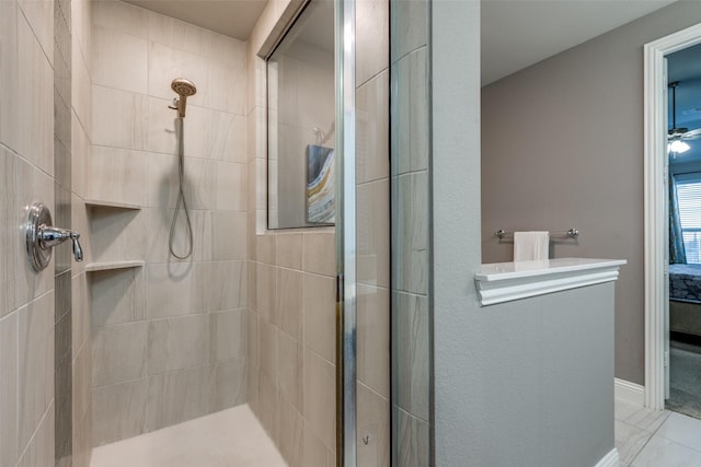 ensuite bathroom with tiled shower, ensuite bathroom, and baseboards