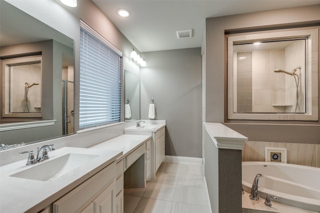 bathroom with vanity, baseboards, a tile shower, a garden tub, and tile patterned floors