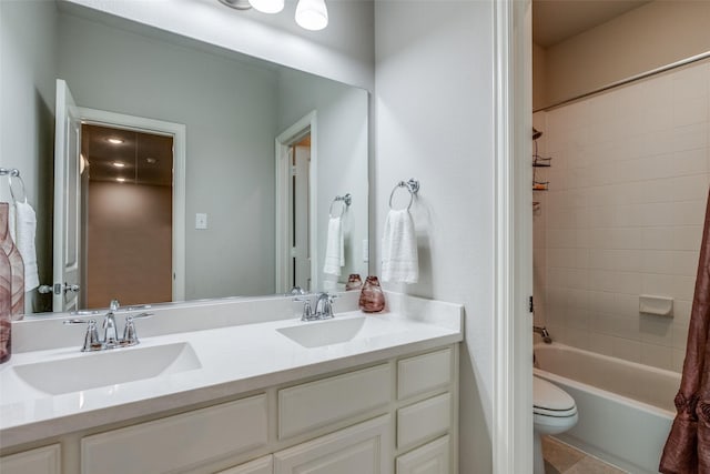 full bath featuring double vanity, toilet, tub / shower combination, and a sink