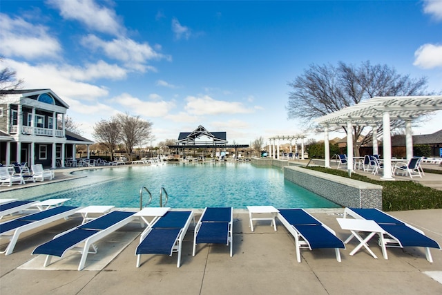 community pool with a pergola and a patio