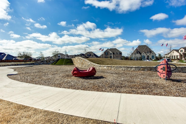 community jungle gym with a residential view