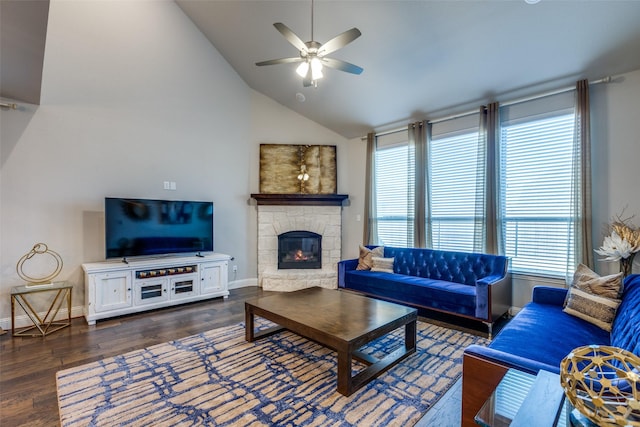 living area with a ceiling fan, baseboards, high vaulted ceiling, a fireplace, and dark wood-type flooring