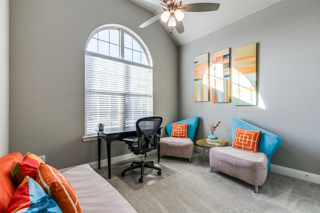 carpeted office space with a ceiling fan, baseboards, and vaulted ceiling