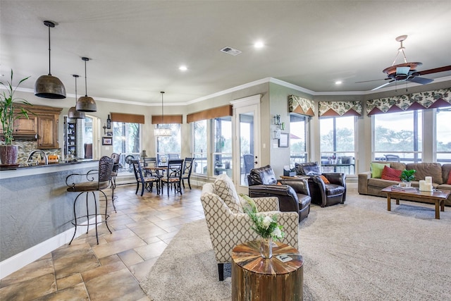 living room featuring plenty of natural light, crown molding, and ceiling fan