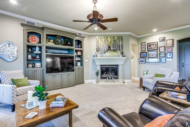 carpeted living room featuring ceiling fan and crown molding