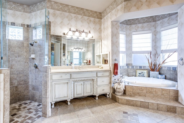 bathroom with vanity, separate shower and tub, and a wealth of natural light