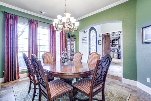 dining room with a chandelier and crown molding