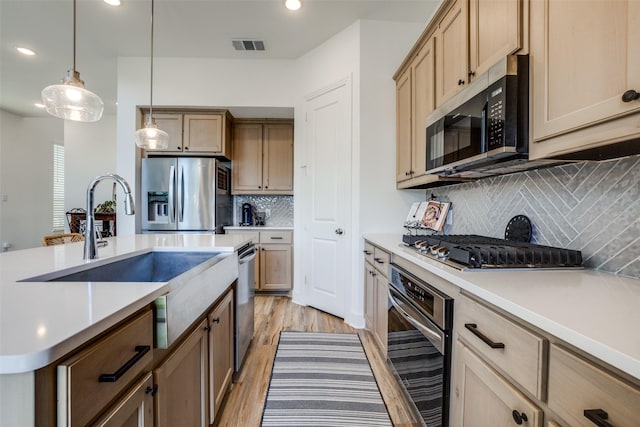 1145 Queensdown Way, Forney, TX 75126 - kitchen featuring appliances with stainless steel finishes, recessed lighting, light wood finished floors, decorative backsplash, and light countertops