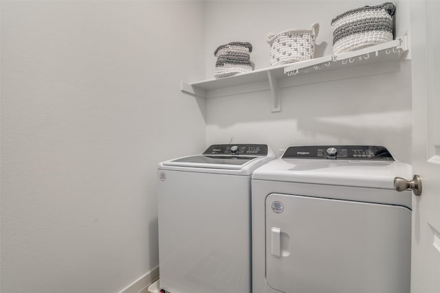 washroom featuring washer and clothes dryer