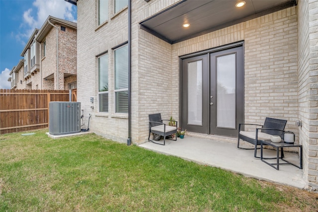 exterior space with a lawn, a patio area, and central AC