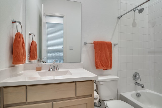 full bathroom featuring vanity, toilet, and tiled shower / bath