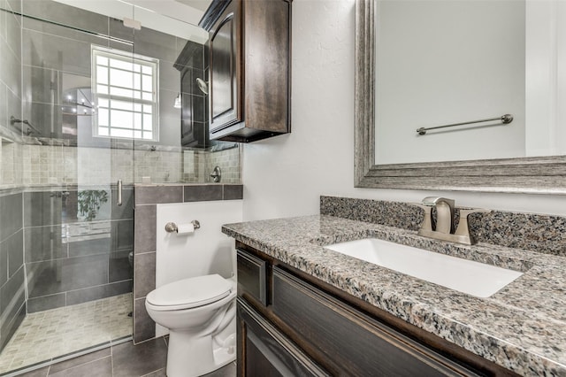 bathroom featuring walk in shower, tile patterned flooring, vanity, and toilet