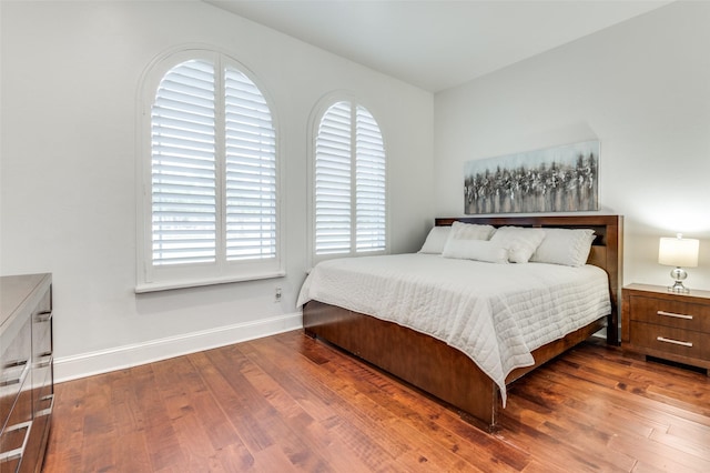 bedroom with dark wood-type flooring