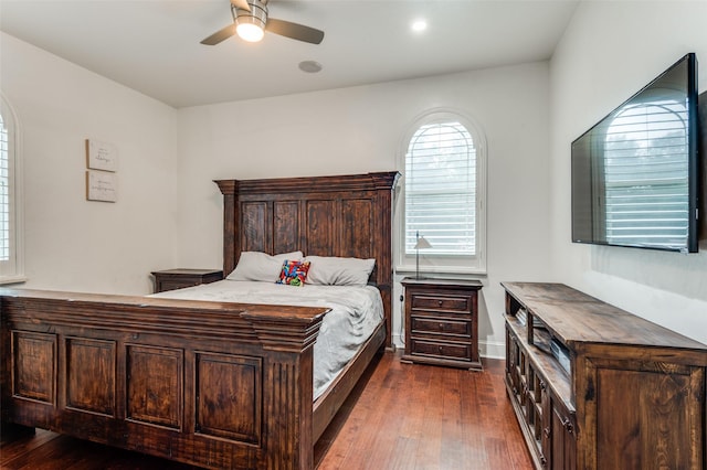 bedroom with ceiling fan and dark hardwood / wood-style floors