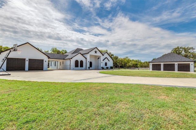 ranch-style house featuring a garage and a front lawn