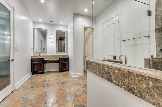 bathroom with vanity and a shower with door