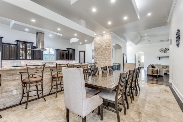 dining room with crown molding and a raised ceiling