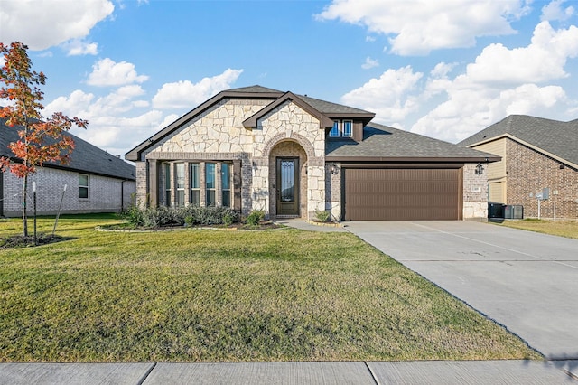 view of front of property with central AC, a garage, and a front lawn