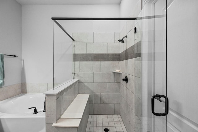 bathroom featuring shower with separate bathtub