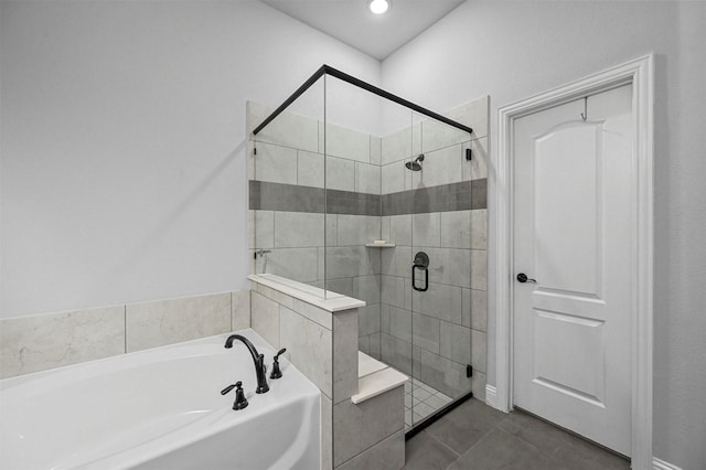 bathroom featuring tile patterned floors and shower with separate bathtub