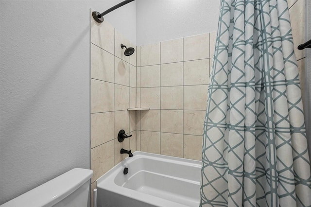 bathroom with shower / tub combo and toilet