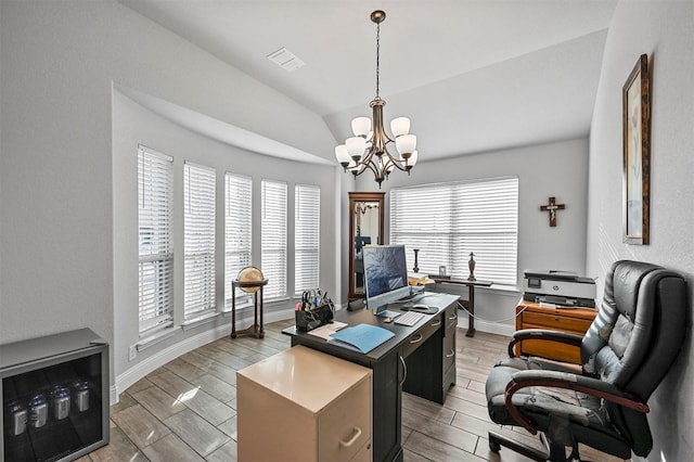 office area with a chandelier, light hardwood / wood-style floors, and vaulted ceiling