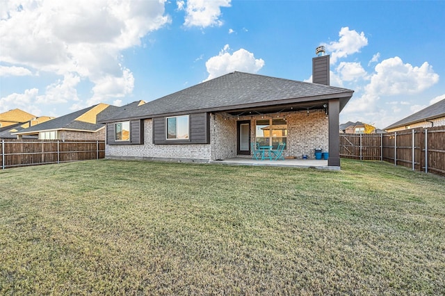 back of property featuring a yard and a patio