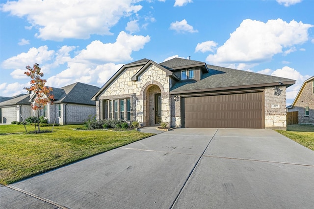 view of front of home with a garage and a front lawn