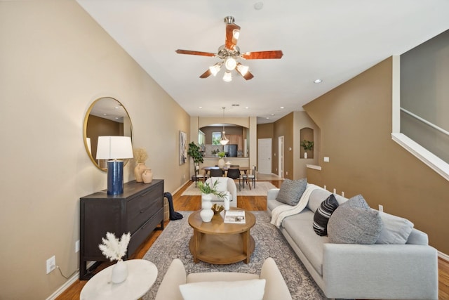 living room with ceiling fan and wood-type flooring