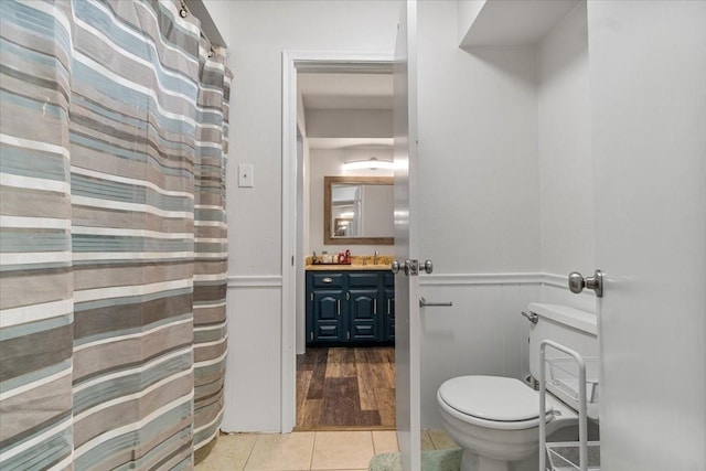 bathroom featuring tile patterned flooring, vanity, and toilet