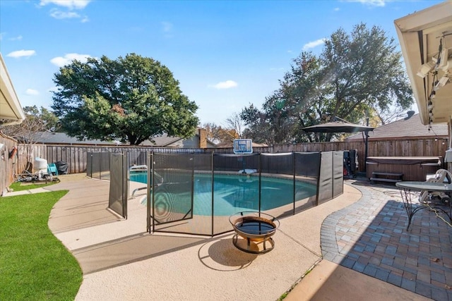 view of swimming pool featuring a patio and a hot tub