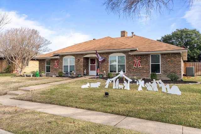 single story home with central AC unit and a front yard