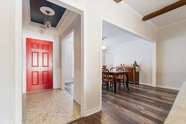 entrance foyer with dark hardwood / wood-style flooring and crown molding