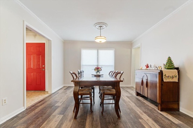 dining space featuring crown molding and wood-type flooring