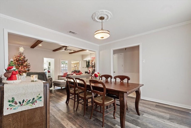 dining space with beamed ceiling, dark hardwood / wood-style floors, ceiling fan, and crown molding