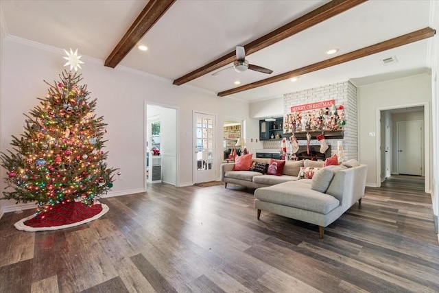 living room featuring beam ceiling, ceiling fan, dark hardwood / wood-style flooring, and ornamental molding