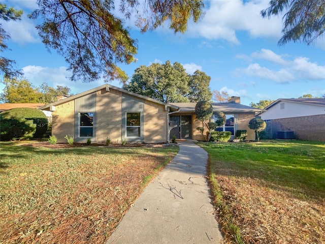 ranch-style home with a front yard and cooling unit