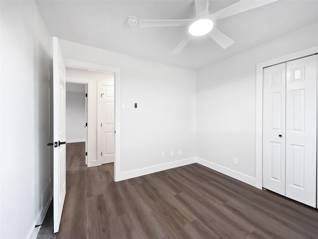 unfurnished bedroom featuring dark hardwood / wood-style flooring, a closet, and ceiling fan