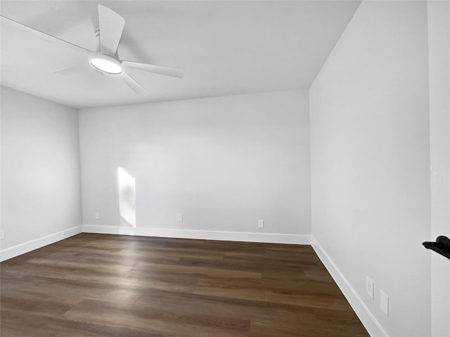 unfurnished room with dark hardwood / wood-style flooring and ceiling fan