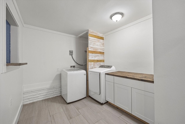 washroom featuring separate washer and dryer and cabinets