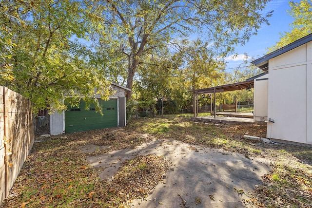 view of yard with an outbuilding, a patio, and a garage