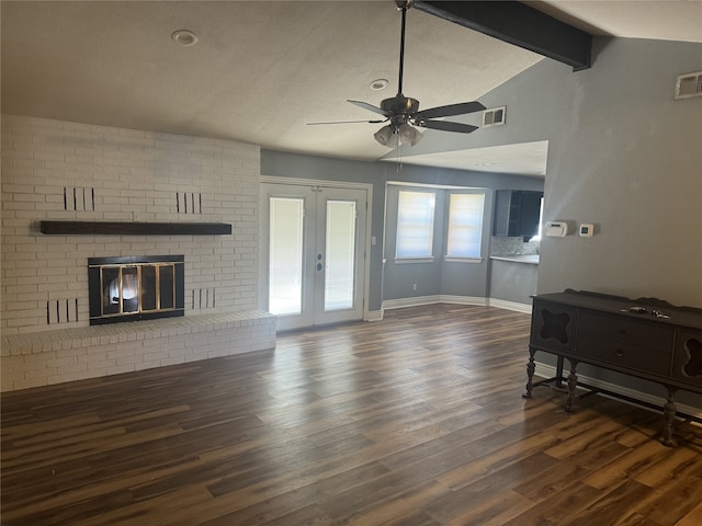 living room with french doors, dark hardwood / wood-style flooring, ceiling fan, a fireplace, and vaulted ceiling with beams