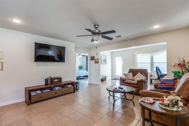 living room with ceiling fan and light tile patterned floors