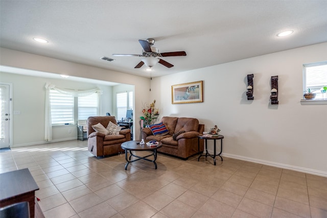 living room with ceiling fan and light tile patterned floors