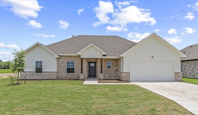 view of front of property with a garage and a front lawn