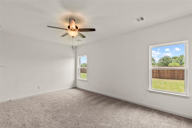 carpeted spare room with ceiling fan