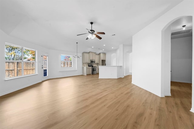 unfurnished living room featuring light wood-type flooring and ceiling fan