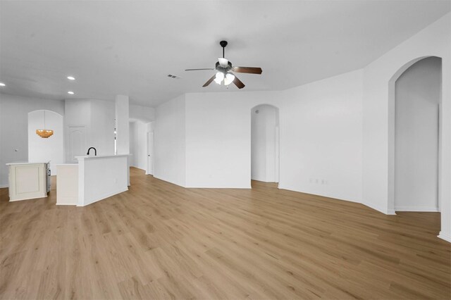 unfurnished living room with light hardwood / wood-style floors and ceiling fan